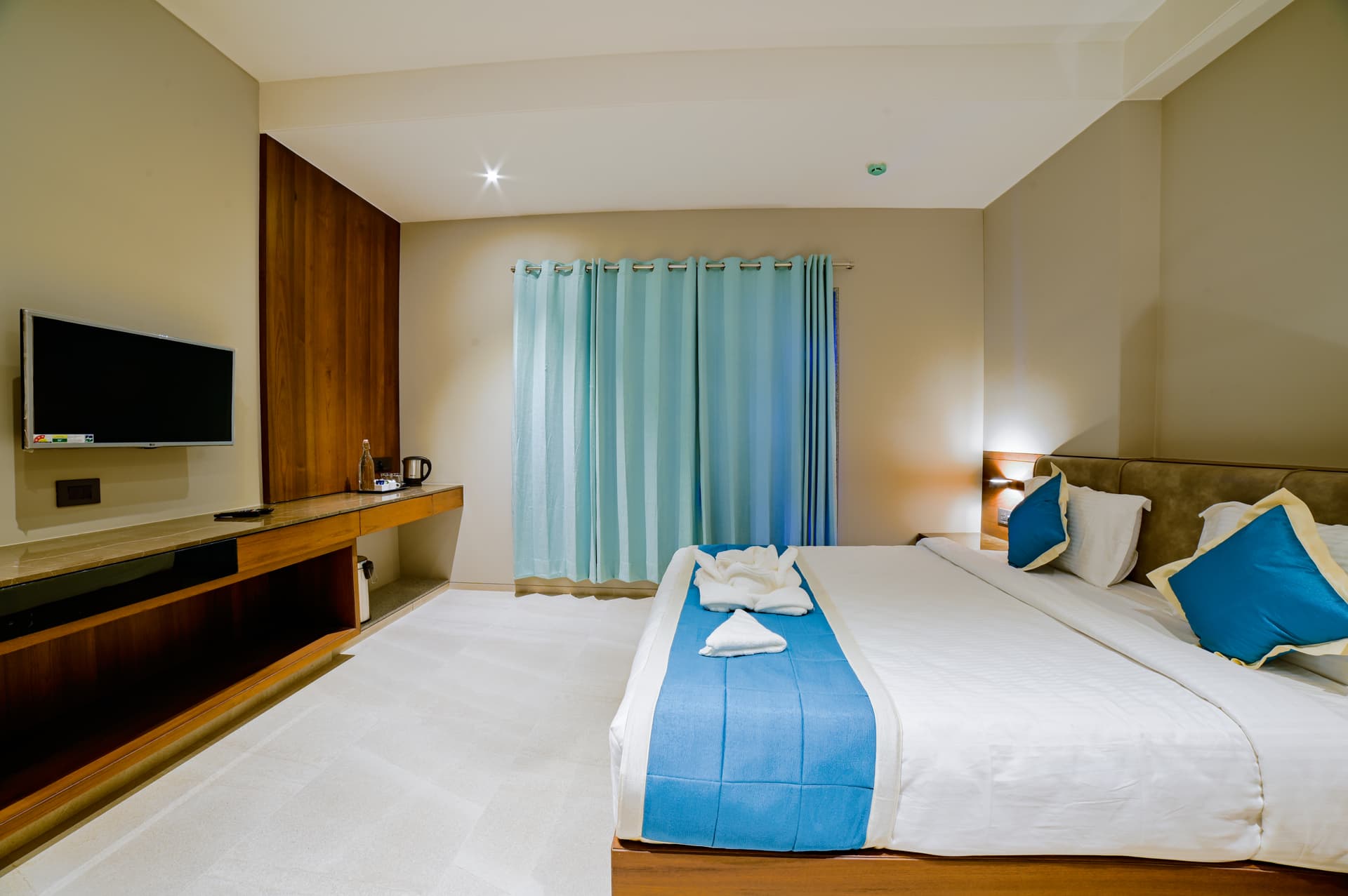 Oriental Room — Spacious Bedroom with Teal Curtains
