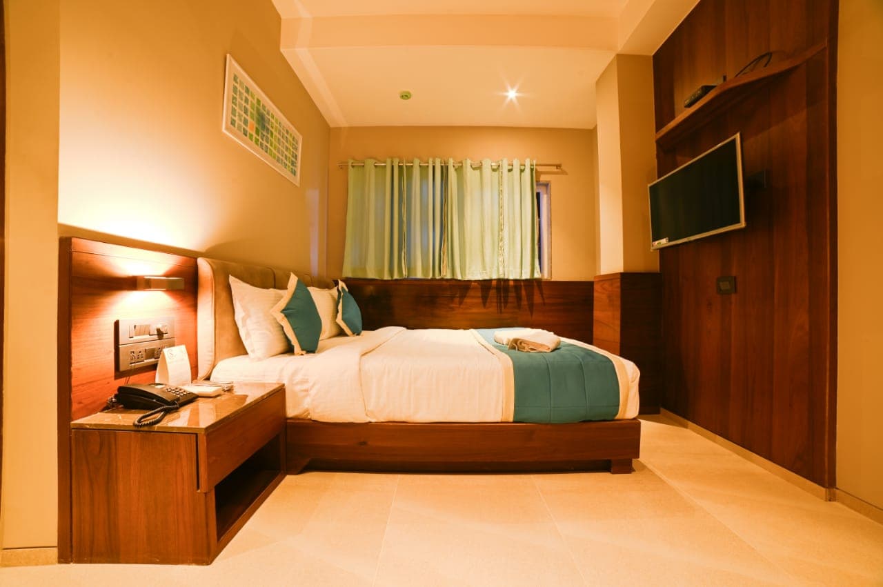 Premium Room — Warm Teal-Accented Bedroom